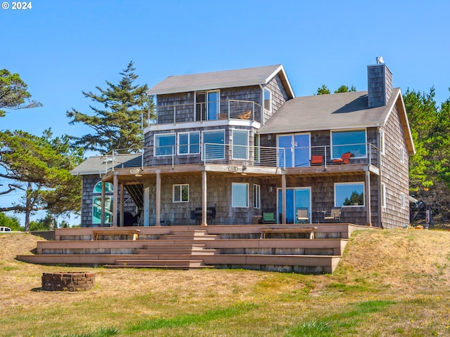 89610 Sea Breeze Dr, Warrenton, OR 97146 - back of house with a chimney, a yard, stairway, and a balcony