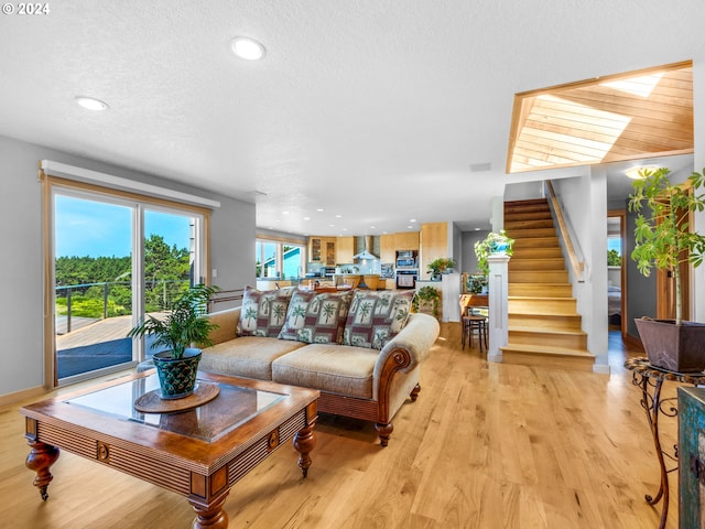 89610 Sea Breeze Dr, Warrenton, OR 97146 - living room featuring stairs, light wood-style flooring, recessed lighting, and a textured ceiling