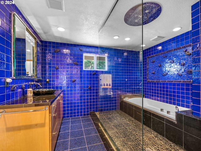 89610 Sea Breeze Dr, Warrenton, OR 97146 - full bath with tile walls, a textured ceiling, visible vents, and tile patterned floors