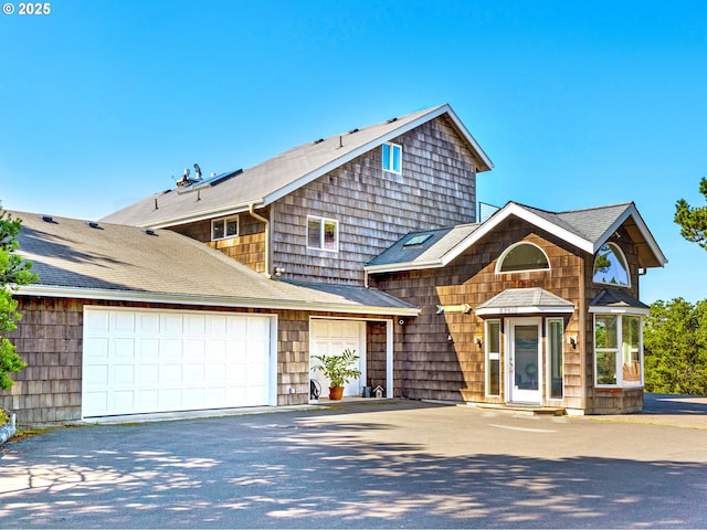 89610 Sea Breeze Dr, Warrenton, OR 97146 - view of front of home with roof with shingles, driveway, and a garage