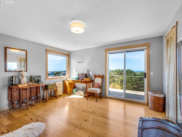 89610 Sea Breeze Dr, Warrenton, OR 97146 - living area with hardwood / wood-style floors and a textured ceiling
