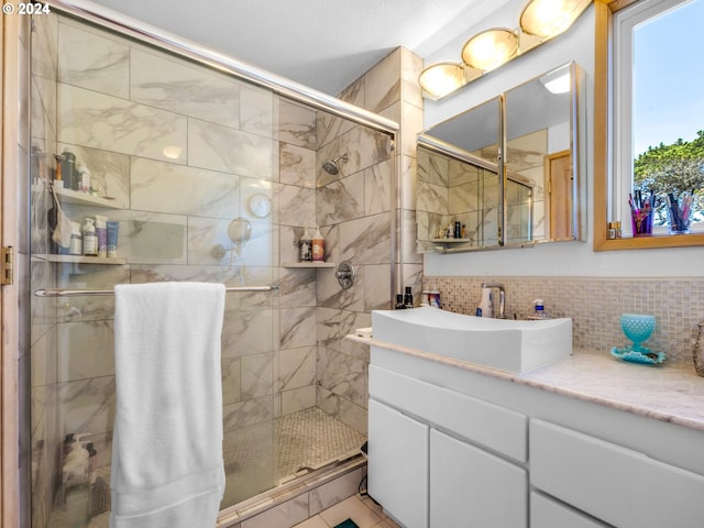 89610 Sea Breeze Dr, Warrenton, OR 97146 - bathroom with a stall shower, vanity, and decorative backsplash