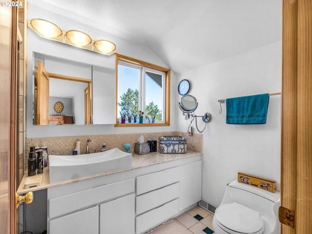 89610 Sea Breeze Dr, Warrenton, OR 97146 - bathroom with vanity, lofted ceiling, backsplash, and toilet