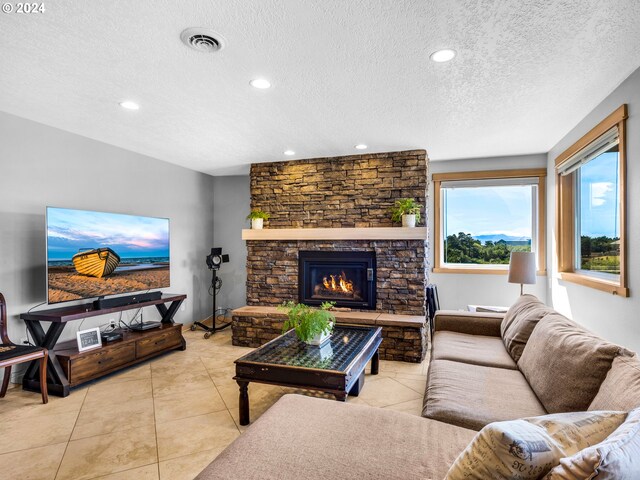 89610 Sea Breeze Dr, Warrenton, OR 97146 - tiled living room featuring recessed lighting, a fireplace, visible vents, and a textured ceiling