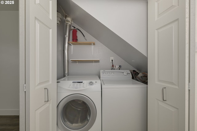 washroom with baseboards, laundry area, washer and clothes dryer, and wood finished floors