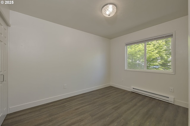 7831 SW 34th Ave, Portland, OR 97219 - spare room with dark wood-type flooring, baseboards, and a baseboard radiator