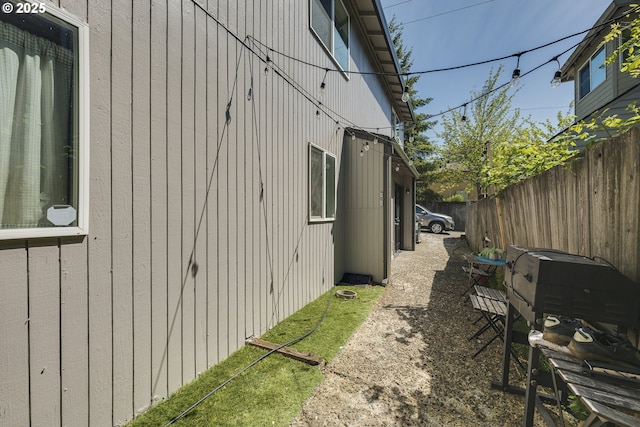 view of side of property featuring fence