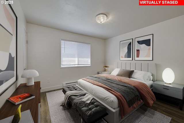 7831 SW 34th Ave, Portland, OR 97219 - bedroom with baseboards, baseboard heating, and wood finished floors