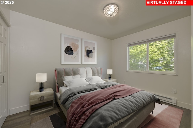 7831 SW 34th Ave, Portland, OR 97219 - bedroom with baseboards, baseboard heating, and wood finished floors