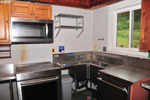 61021 Landreth Ln, Saint Helens, OR 97051 - kitchen with stainless steel microwave, electric range oven, black dishwasher, and brown cabinets