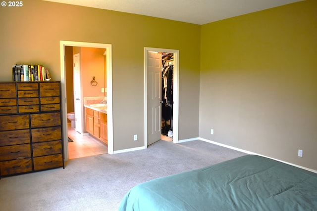 1216 SE 47th St, Hillsboro, OR 97123 - bedroom with light colored carpet, a spacious closet, baseboards, ensuite bath, and a sink