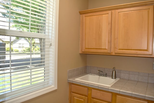 1216 SE 47th St, Hillsboro, OR 97123 - kitchen featuring tile counters, a sink, healthy amount of natural light, and light brown cabinets