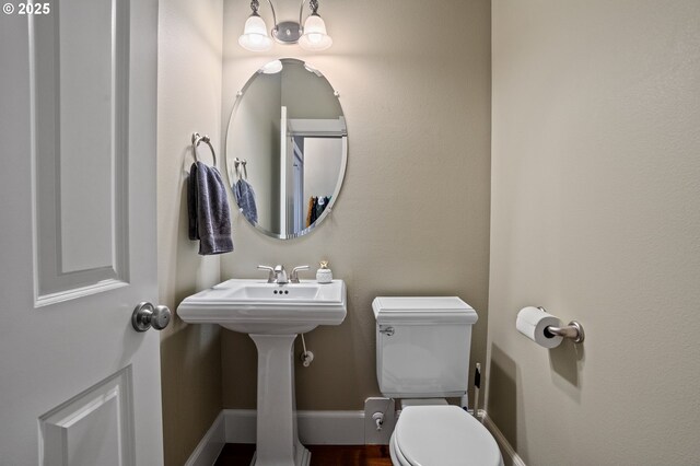 half bathroom featuring toilet