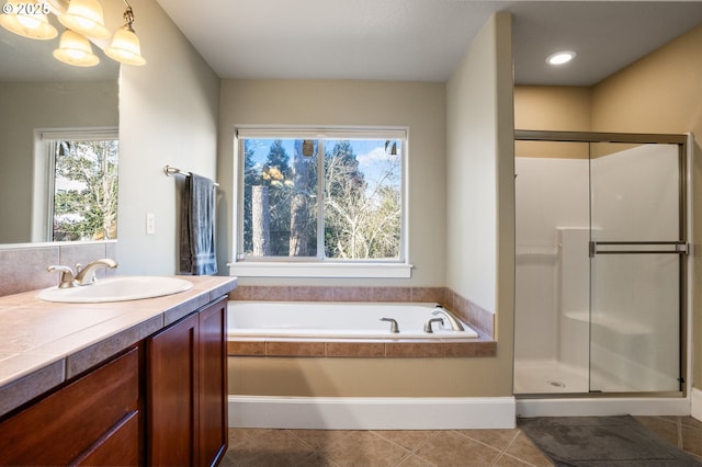 full bathroom with a shower stall, vanity, a garden tub, and tile patterned floors