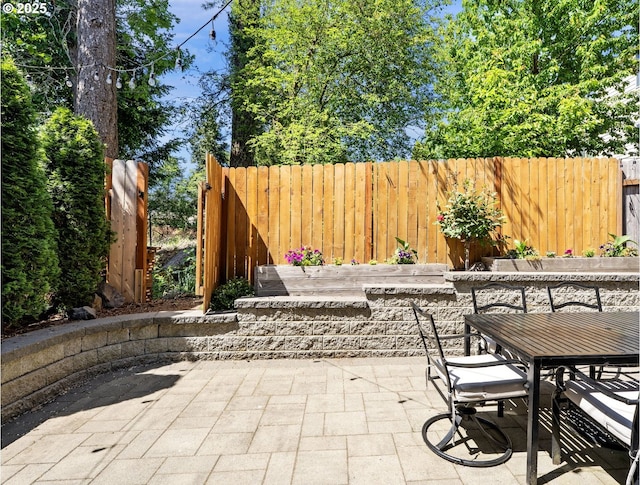 view of patio / terrace with outdoor dining area and fence