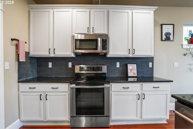 kitchen featuring appliances with stainless steel finishes, decorative backsplash, and white cabinetry