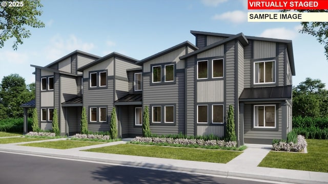 townhome / multi-family property with metal roof, a standing seam roof, and a front lawn