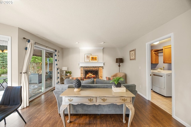 8967 SW Leslie St, Portland, OR 97223 - living room with washer / clothes dryer, wood finished floors, a fireplace, and baseboards