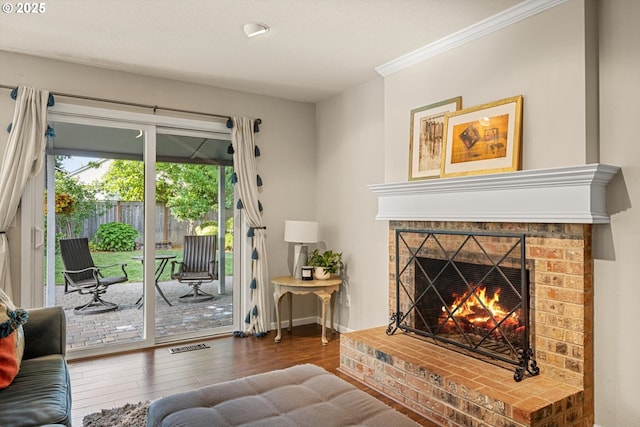 8967 SW Leslie St, Portland, OR 97223 - living area with wood finished floors, a fireplace, ornamental molding, and baseboards