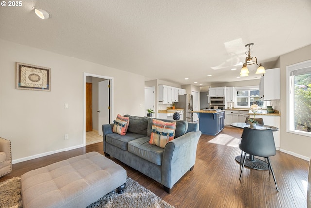 8967 SW Leslie St, Portland, OR 97223 - living area featuring dark wood-style flooring, baseboards, and recessed lighting