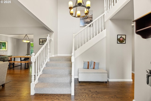 8967 SW Leslie St, Portland, OR 97223 - stairs featuring a chandelier, wood finished floors, baseboards, and a high ceiling
