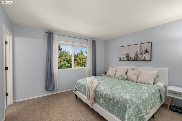 carpeted bedroom featuring baseboards