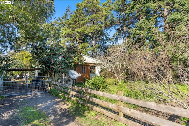 exterior space featuring fence and an outbuilding