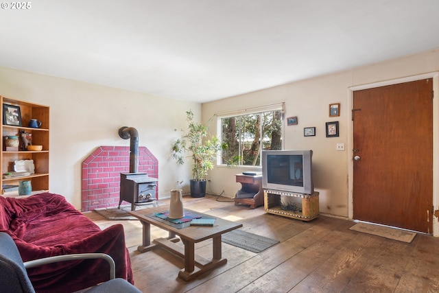 living area featuring hardwood / wood-style floors and a wood stove