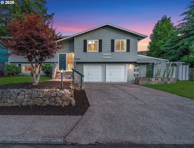 view of front of home featuring concrete driveway, stone siding, and an attached garage