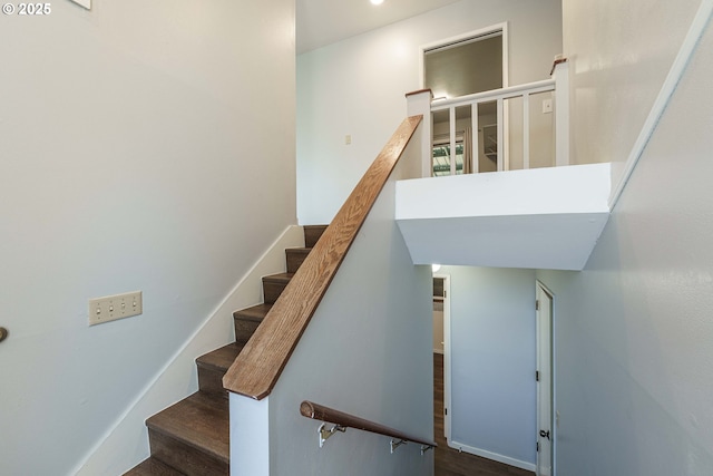 stairs featuring wood-type flooring