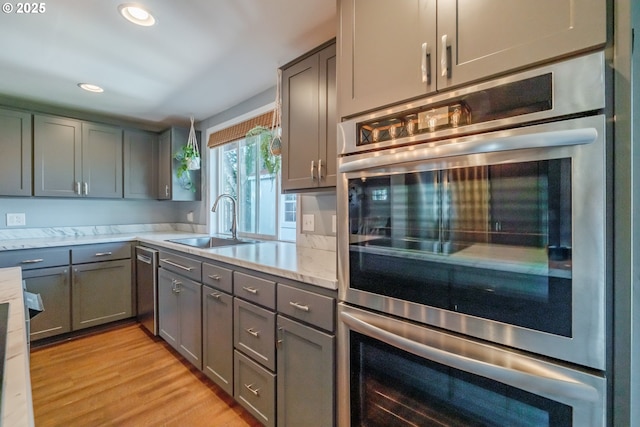 6132 Wilford Pl SW, Albany, OR 97321 - kitchen featuring appliances with stainless steel finishes, gray cabinets, recessed lighting, light wood-style floors, and light stone counters