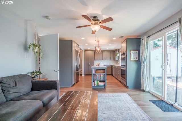 6132 Wilford Pl SW, Albany, OR 97321 - kitchen with open floor plan, gray cabinetry, appliances with stainless steel finishes, light wood finished floors, and light countertops