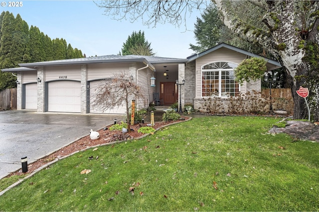 ranch-style home with a front yard and a garage