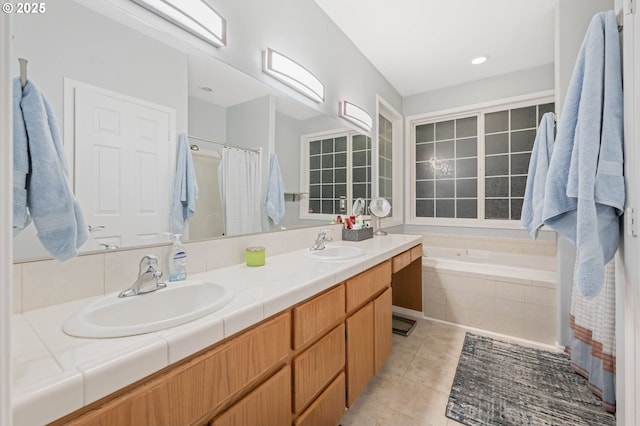 bathroom with tile patterned flooring, vanity, and shower with separate bathtub