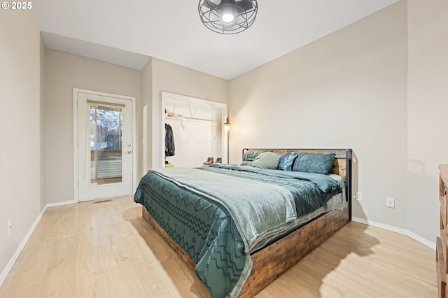 bedroom with access to outside and light hardwood / wood-style flooring