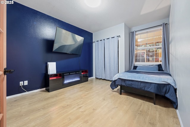 bedroom featuring hardwood / wood-style floors and a textured ceiling