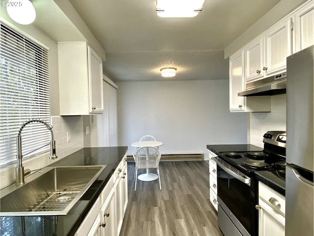 8416 SE Insley St, Portland, OR 97266 - kitchen featuring white cabinets, under cabinet range hood, wood finished floors, a sink, and appliances with stainless steel finishes