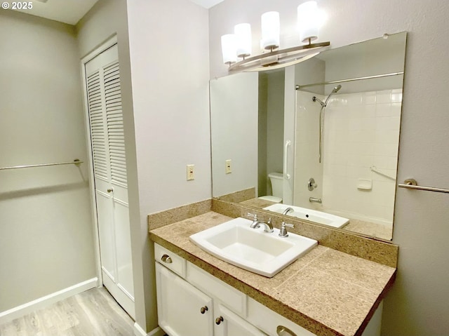 8416 SE Insley St, Portland, OR 97266 - bathroom featuring vanity, baseboards, toilet, and wood finished floors