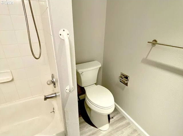 8416 SE Insley St, Portland, OR 97266 - full bathroom featuring shower / bathtub combination, baseboards, toilet, and wood finished floors