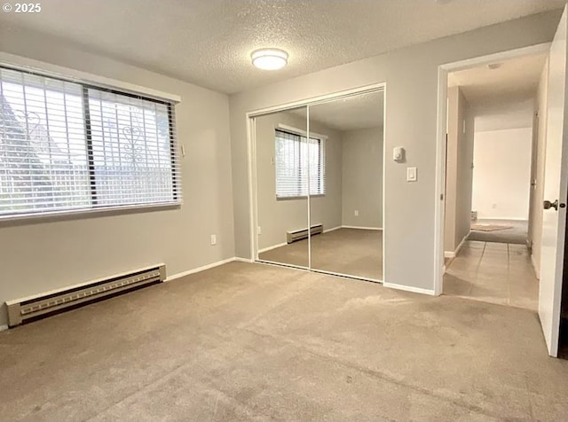 8416 SE Insley St, Portland, OR 97266 - unfurnished bedroom with a baseboard radiator, a textured ceiling, and carpet floors