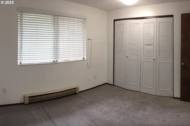 8416 SE Insley St, Portland, OR 97266 - unfurnished bedroom with a closet, baseboards, a textured ceiling, carpet floors, and a baseboard heating unit