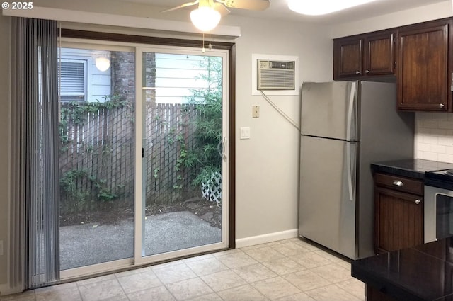 8416 SE Insley St, Portland, OR 97266 - kitchen with dark brown cabinetry, a ceiling fan, a wall mounted AC, appliances with stainless steel finishes, and decorative backsplash
