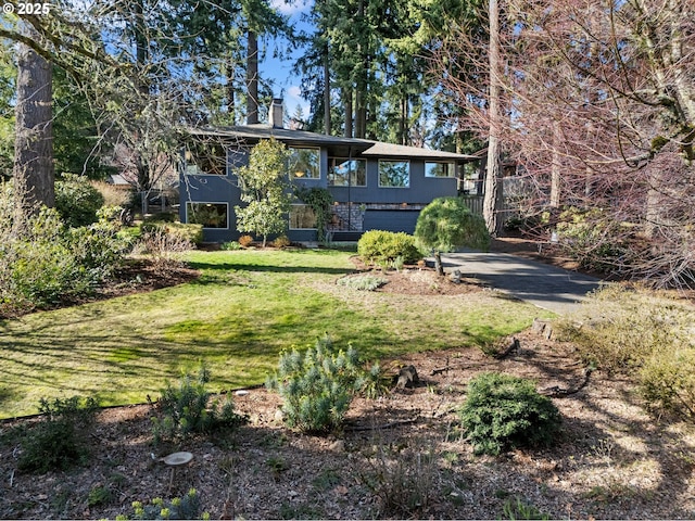 exterior space with a lawn and a chimney