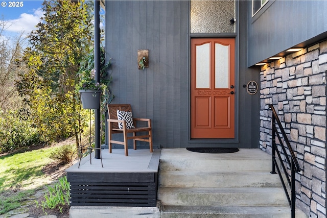 doorway to property with stone siding