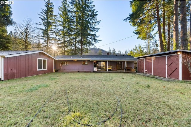 rear view of house featuring a yard