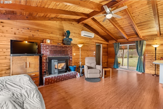 unfurnished living room featuring vaulted ceiling with beams, hardwood / wood-style flooring, wooden walls, and a wall mounted AC