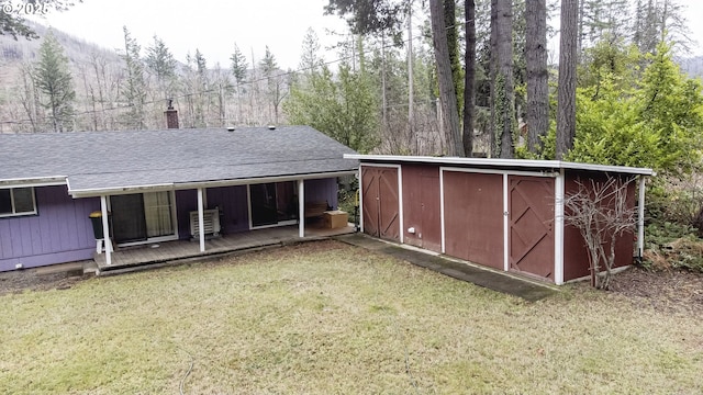49855 Mckenzie Hwy, Vida, OR 97488 - back of house featuring a lawn, an outdoor structure, a chimney, and a forest view