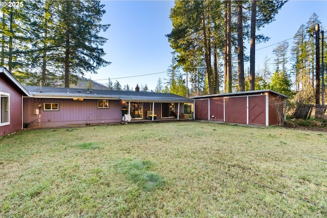 rear view of property featuring a yard