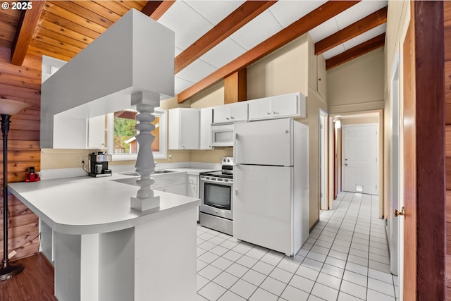 kitchen with white cabinets, light tile patterned floors, white appliances, kitchen peninsula, and beam ceiling