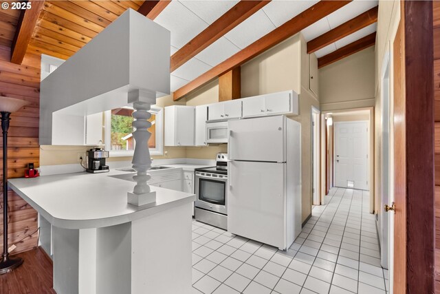 49855 Mckenzie Hwy, Vida, OR 97488 - kitchen featuring white appliances, beam ceiling, a peninsula, light countertops, and white cabinetry